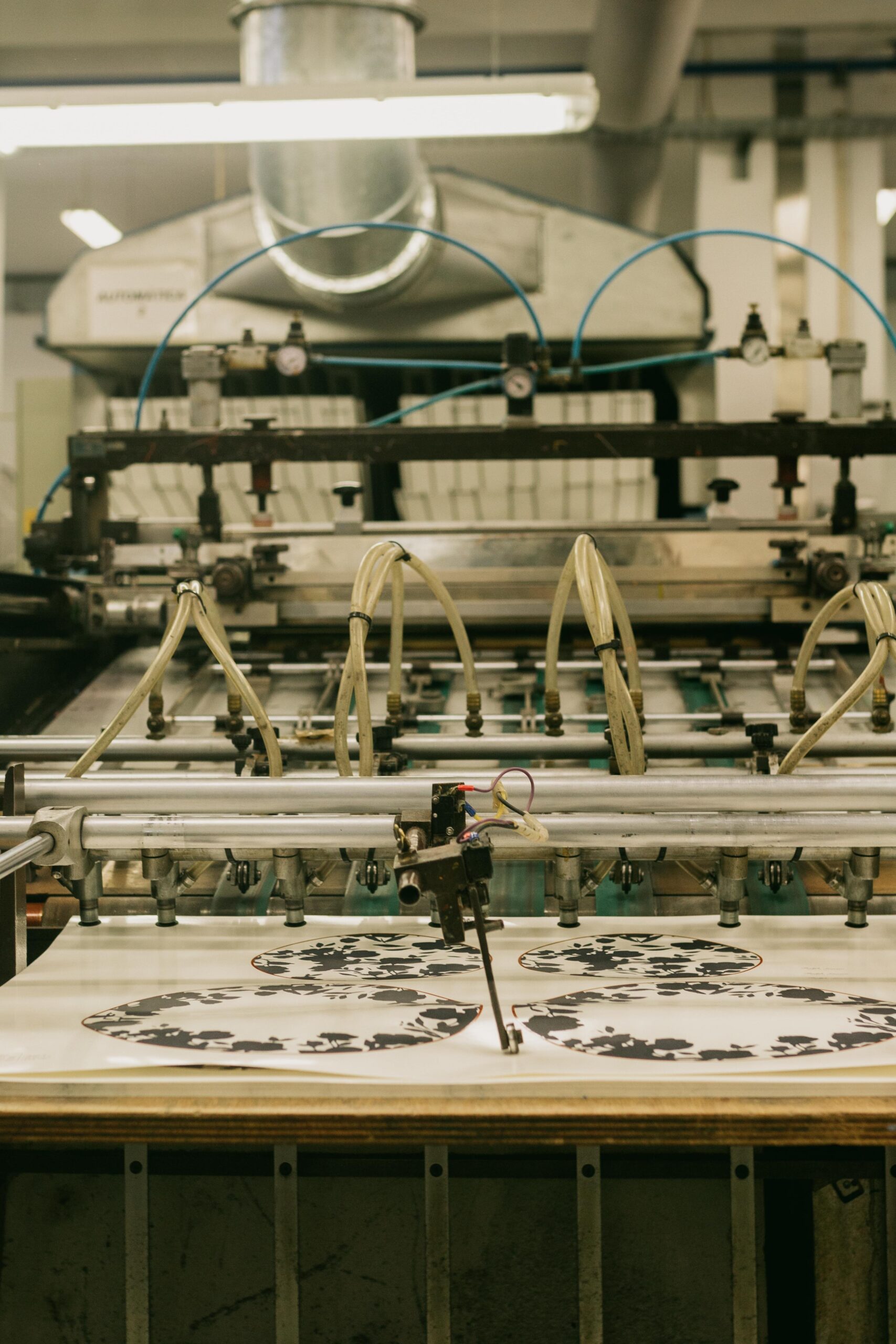 Close-up view of a printing machine inside a Porto factory, showcasing industrial automation.