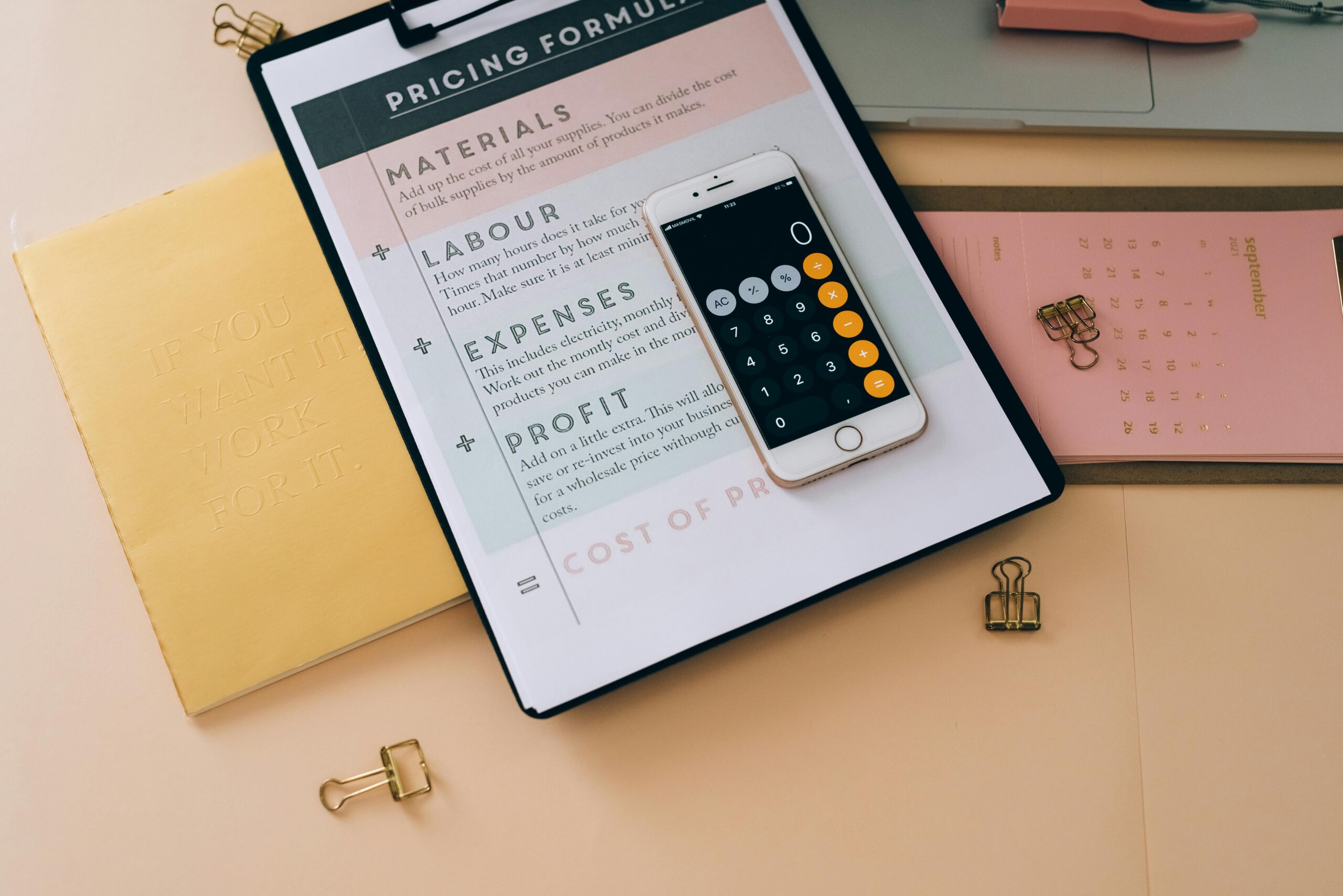 Organized business tools with a smartphone, documents, and stationery in a flat lay format.