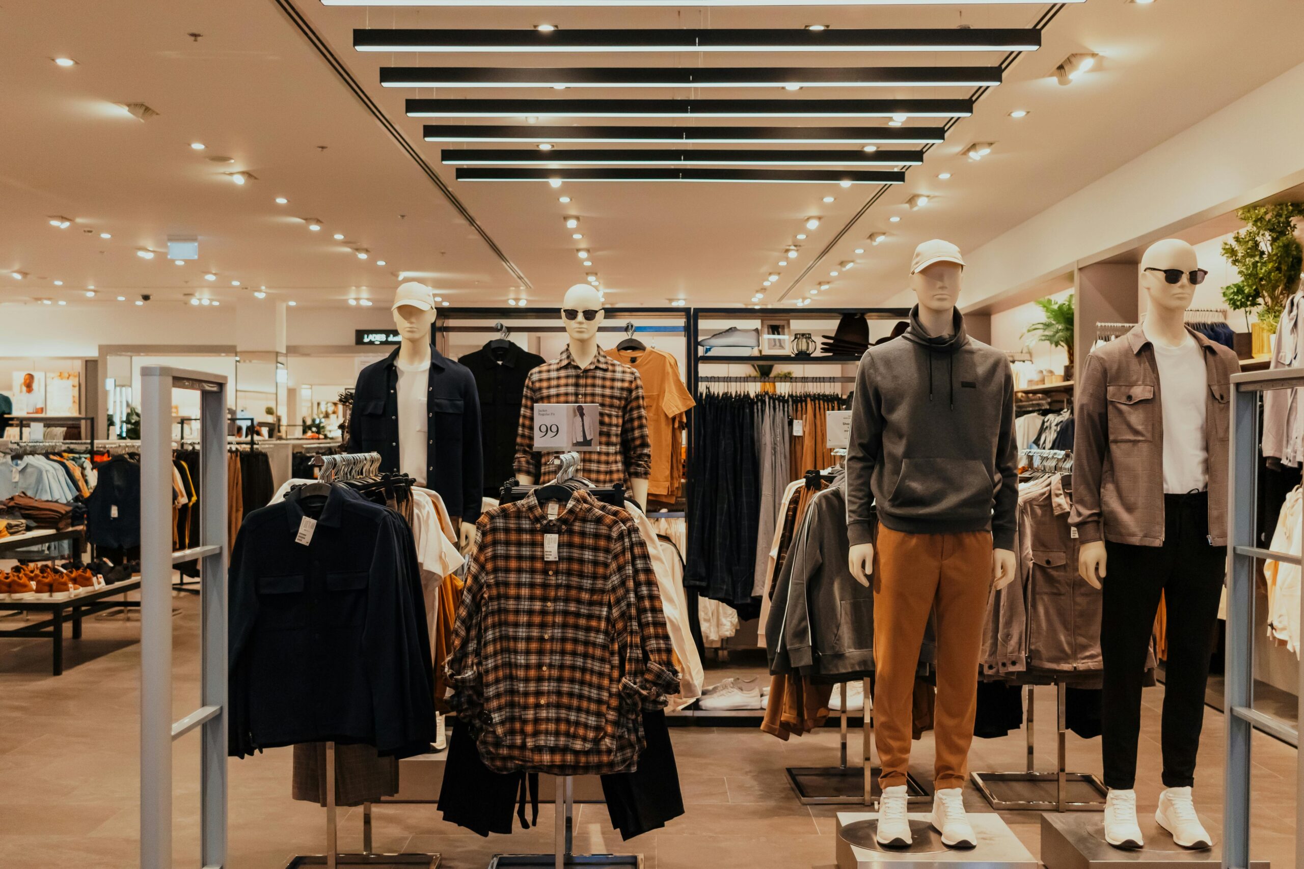 Stylish clothing display in a modern Dubai retail store, featuring mannequins.